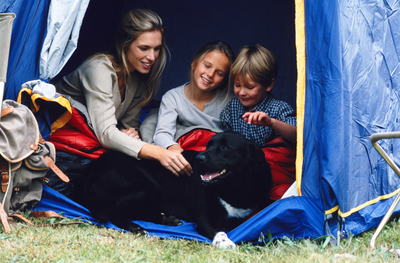 mother with children in tent with dog